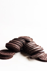 Chocolate sandwich cookies with cream filling on white background.