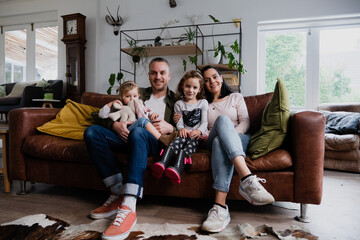 Caucasian family together on the couch at home 