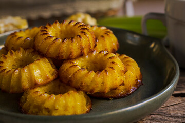 Brazilian typical small corn cake on rustic background close up horizontal