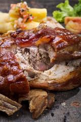 Typical Brazilian roasted pork knee with crackling vertical