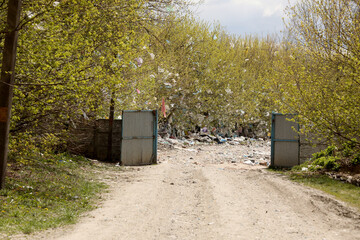 entrance to the landfill. Pile of domestic garbage in landfill dump site.