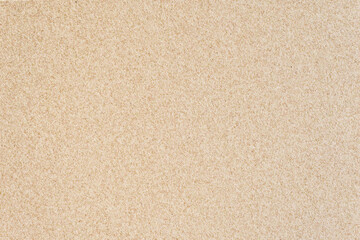Obraz na płótnie Canvas Textured sand background. Decorative wall plaster, interior decoration. Background image of a wall with beige textured coating.
