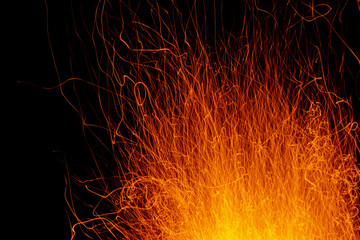 A strong bonfire erupts into the sky at night. Deep night and exposure