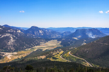 Vista from Rainbow Curve overlook, Rocky Mountain National Park looking down on Horseshoe Park grassy valley floor, Fall River, alluvial fan and Trail Ridge Road switchback. Colorado, USA