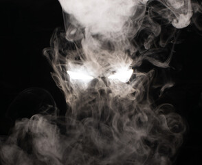 Ominous luminous eyes looking out of the darkness illuminate the swirling smoke with rays of white light