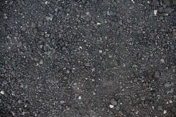 Texture small black stone. Road surface base