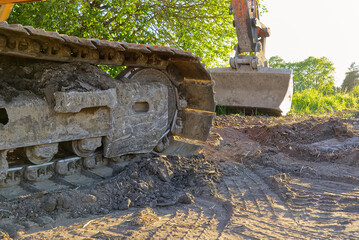 excavator tracks close-up. Construction equipment during road works. Excavator tracks construction industry.