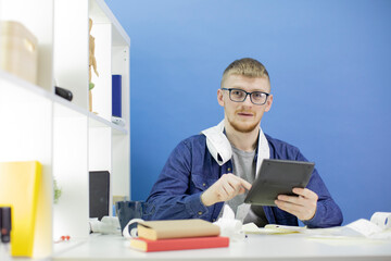 Portrait of frustrated caucasian male in glasses, dressed in casuals looks confusedly into the...