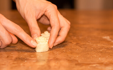 A woman makes cookies in the shape of a rosebud. Step by step tutorial.