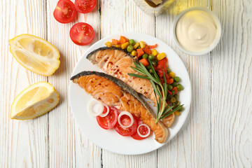 Composition with tasty grilled salmon on wooden background, top view