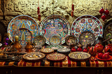 Colored ceramic dishes and other kitchen utensils on a lighten stone background