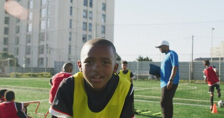 African American soccer kid exercising in a sunny day