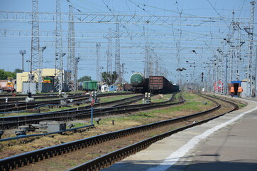 Fototapeta na wymiar railway station diesel locomotive hauling a passenger train through a railway station