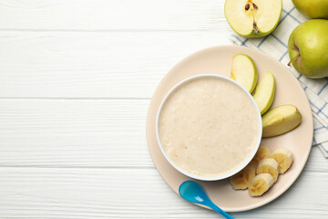 Composition with baby food on white wooden background