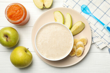 Composition with baby food on white wooden background