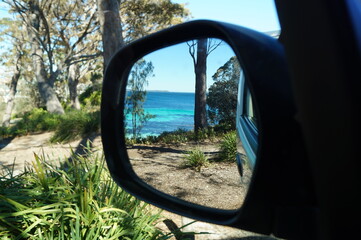 Roadtrip view from the side mirror at the sea