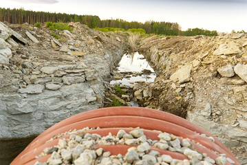 construction of a drainage ditch with plastic pipes. development of a new residential area in the...