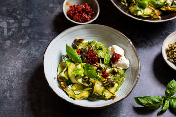 Vegetarian dish with courgette, pesto and pumpkin seeds