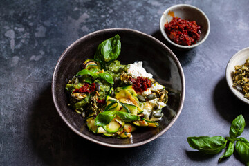 Vegetarian dish with courgette, pesto and pumpkin seeds