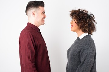 Profile of smiling woman with healthy pure skin, has contemplative expression, ready to have outdoor walk, isolated over white studio wall with copy space