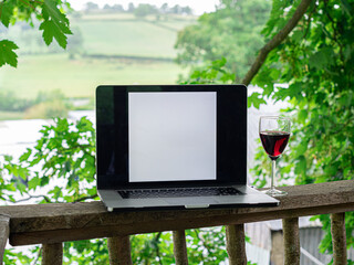 MacBook laptop with blank screen for business logo outside on a terrace with a view