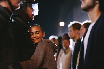 Woman activist hugging a policeman