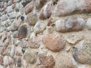 High fence of large boulders of stones reliably protects the estate