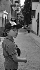 little boy in the street with scatebord