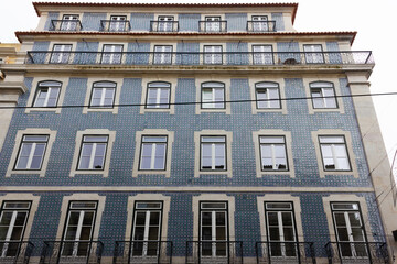 Fototapeta na wymiar Traditional Portuguese building with blue tiles facade in Lisbon on cloudy day
