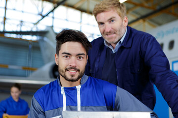 two mechanics looking at the camera