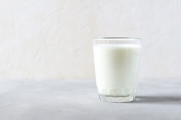 Homemade fermented beverage in a glass - kefir, cottage cheese, on a white background. Sour milk drink, yeast for yeast bacterial fermentation, intestinal health concept. Fashionable food and drinks