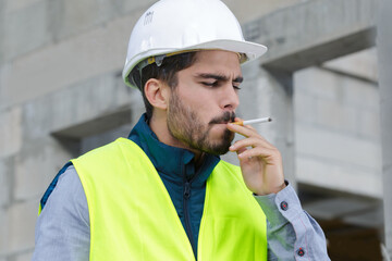 male builder smoking cigarette outside