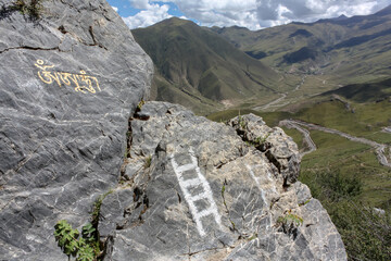 Painted white ladder rocks on a hiking trail around Drepung monastery near Lhasa, Tibet, Asia