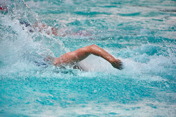 Athlete training swimming in wave pool at gym blue water splashing competition