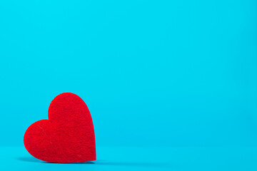Bright red heart on a blue background in the left corner