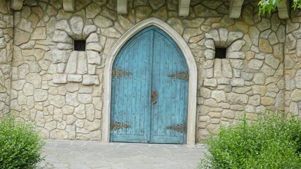 old blue wooden door in a stone wall