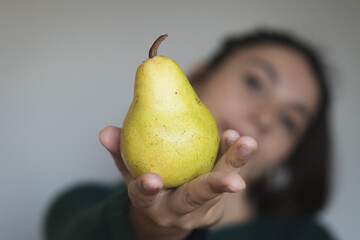 Woman holding a pear 