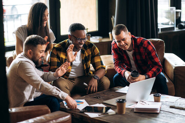 Group video conference. Young successful business team communicates via video conference with their...