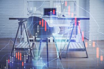 Double exposure of financial graph drawing and office interior background. Concept of stock market.