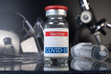 coronavirus vaccine container displayed on glass shelf in laboratory