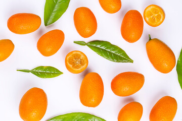 Top view of bunch of fresh kumquats in the organic food market. Some kumquats is cutted.