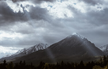 Dramatic sky with sunbeams breaking through heavy clouds over the Slavkovsky siit (peak) is the fourth highest mountain peak in the High Tatra mountains in Slovakia.