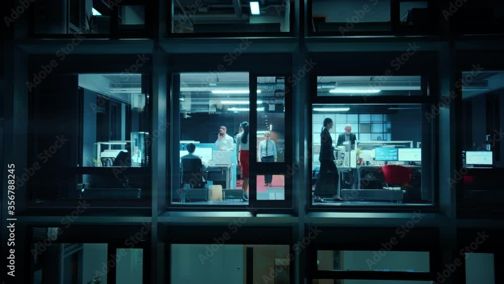Poster footage from outside the window: businessmen and businesswomen working in the office. managers and s