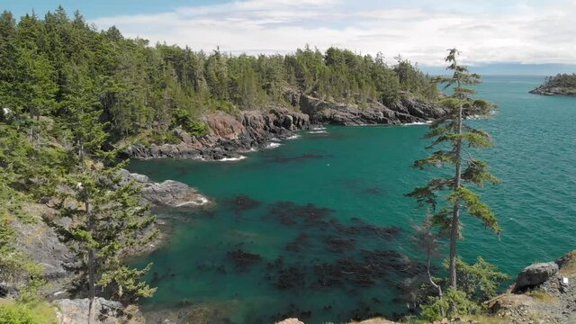 A aerial drone shot of the beautiful coastline with turquoise water near Sooke, BC. 4K 24FPS.