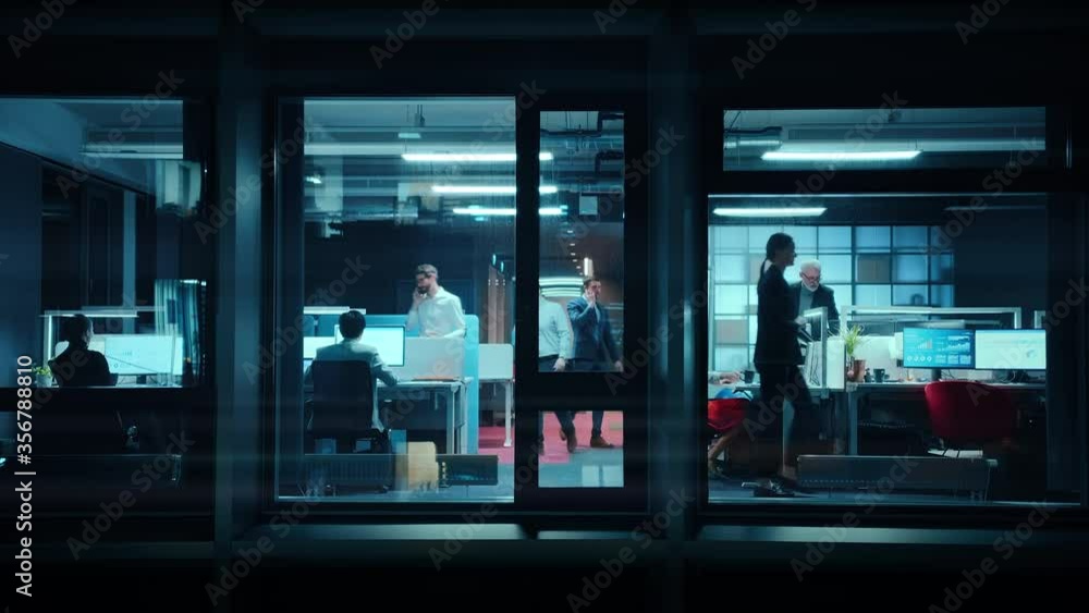 Poster footage from outside the window: businessmen and businesswomen working in the office. managers and s