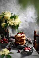  Breakfast Pancakes with  Cherries, Homemade American pancakes served withfresh cherry on a wooden background, sweet dessert 
