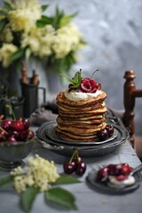  Breakfast Pancakes with  Cherries, Homemade American pancakes served withfresh cherry on a wooden background, sweet dessert 