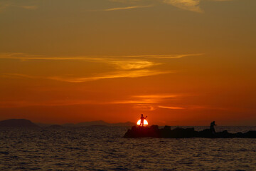 Fototapeta na wymiar fishing in the sunset. Seaside town of Turgutreis and spectacular sunsets