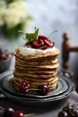  Breakfast Pancakes with  Cherries, Homemade American pancakes served withfresh cherry on a wooden background, sweet dessert 