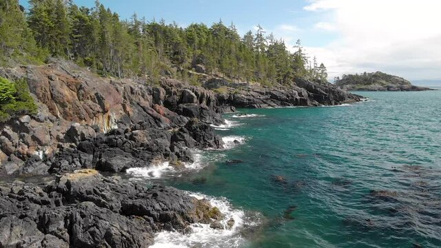 A aerial drone shot of the beautiful coastline with turquoise water near Sooke, BC. 4K 24FPS.